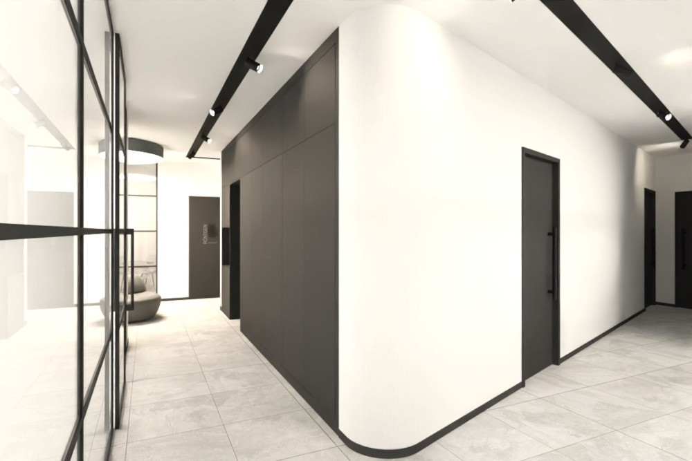 Heller, geradliniger Flurbereich einer neuen kieferorthopädischen Praxis in Düsseldorf. Links zieht sich eine bodentiefe Glaswand mit schwarzen Metallrahmen entlang, dahinter wirkt ein angrenzender Raum hell und offen; im Hintergrund ist eine runde, graue Sitzinsel oder gepolsterte Bank zu erkennen. Der Boden besteht aus hellgrauen, großformatigen Fliesen. In der Mitte dominiert ein großer, abgerundeter Wandkörper in Weiß, der wie ein Raumteiler wirkt und die Wegeführung lenkt. Rechts sind mehrere dunkelgraue Türen in die weißen Wände eingelassen. Links am Wandkörper verläuft eine große, dunkelgraue Einbaufassade oder Schrankwand mit glatten Fronten. An der Decke sind schwarze Lichtschienen mit mehreren kleinen Spotleuchten montiert, die den Flur gleichmäßig ausleuchten. Insgesamt entsteht ein sehr modernes, ruhiges Erscheinungsbild mit klaren Kontrasten aus Weiß, Grau und Schwarz.